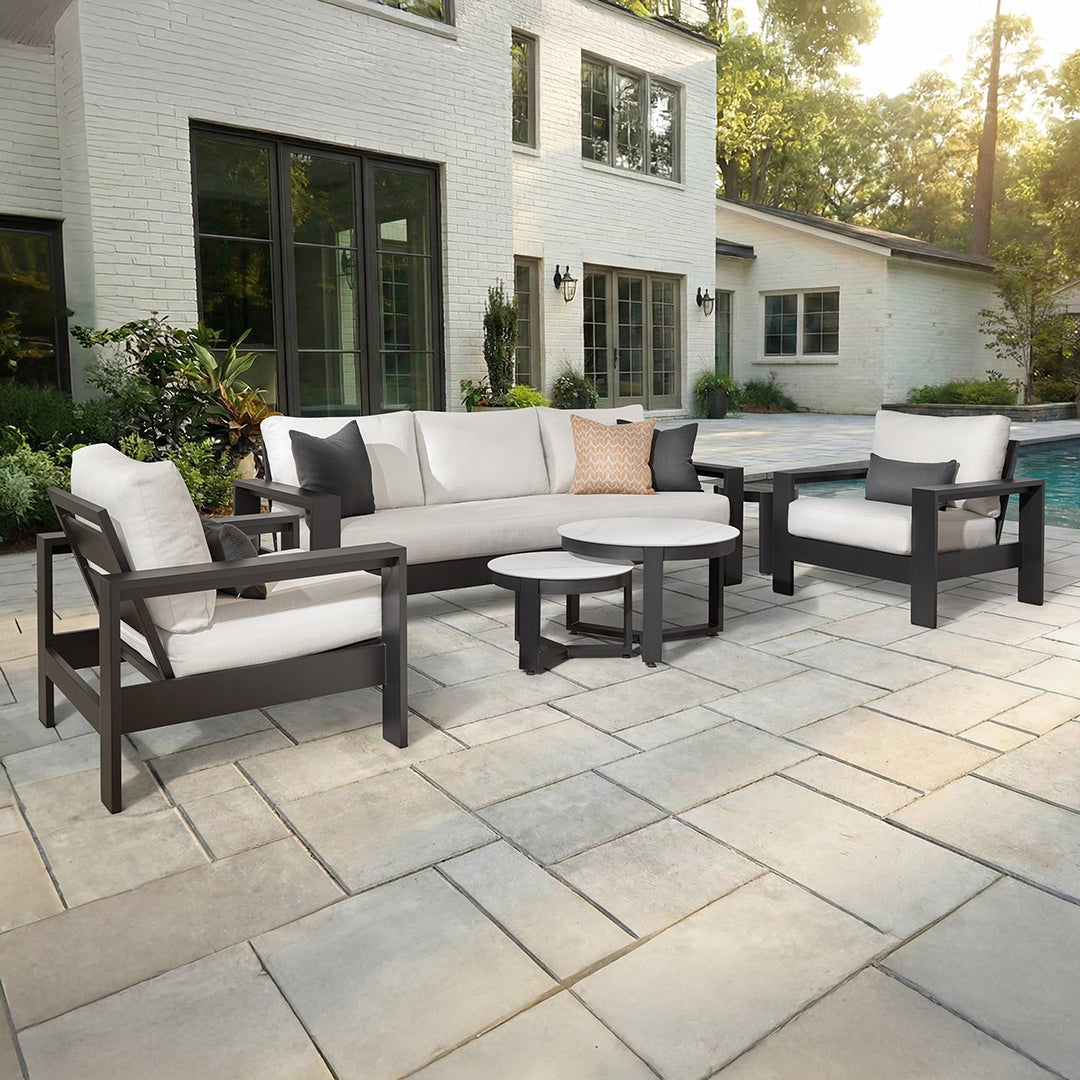 Outdoor patio furniture set with white cushions.
