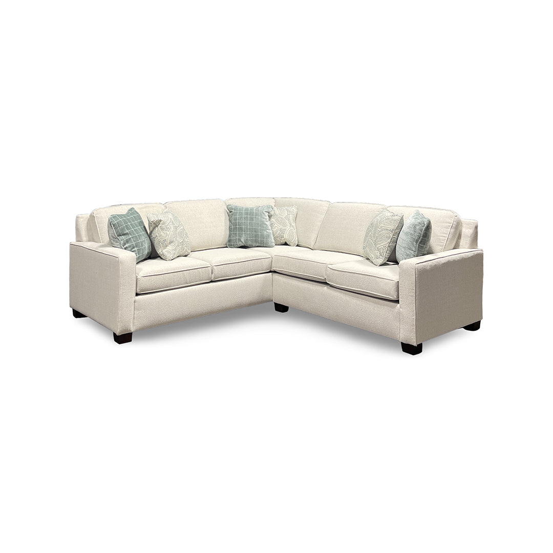 Beige sectional sofa with printed accent pillows