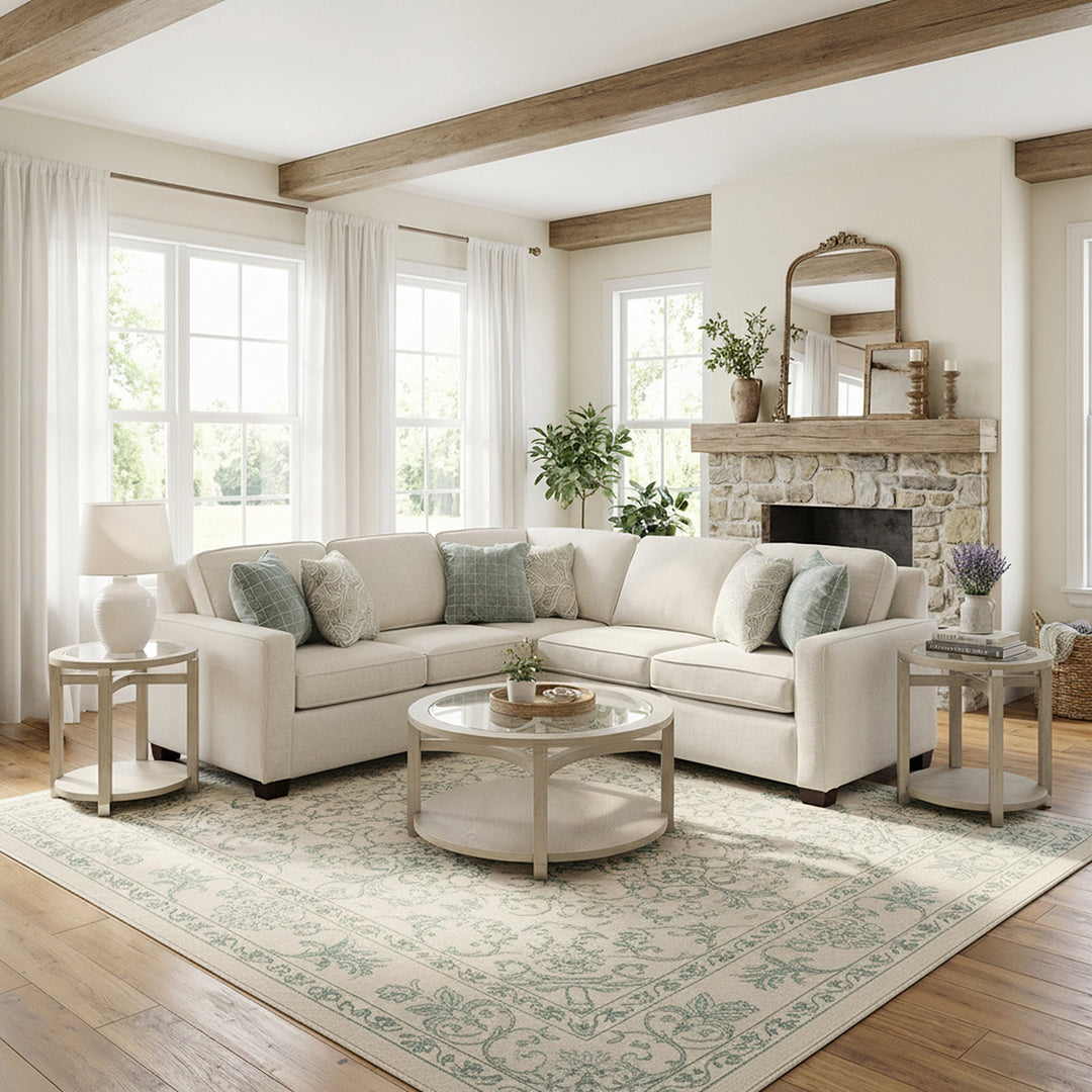 Cozy living room with a beige sectional sofa, round coffee table, and decorative elements.