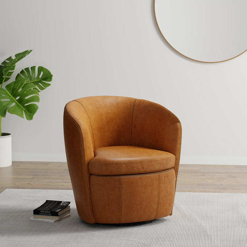 Cognac leather 360-degree swivel accent chair styled in a modern living room setting