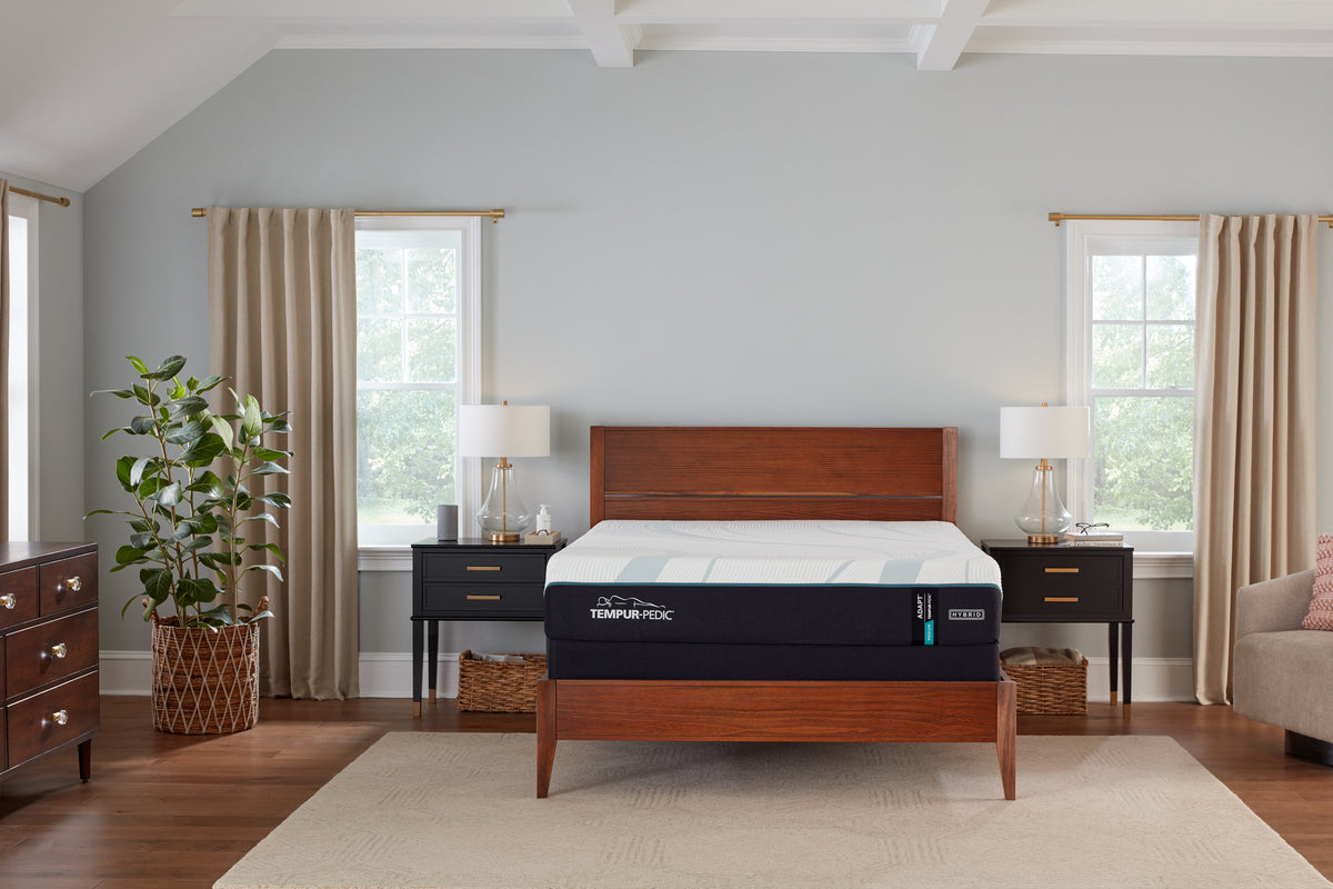 Clean, modern bedroom setup with upholstered bed, nightstands, and supportive mattress foundation