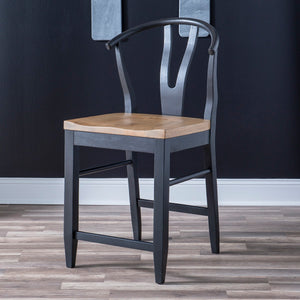Franklin Wishbone Side Chair in Counter height. Harvest Oak seats on quartered white oak veneer sit atop aged black painted bases with interesting curves throughout the design. Available in Dining Height.