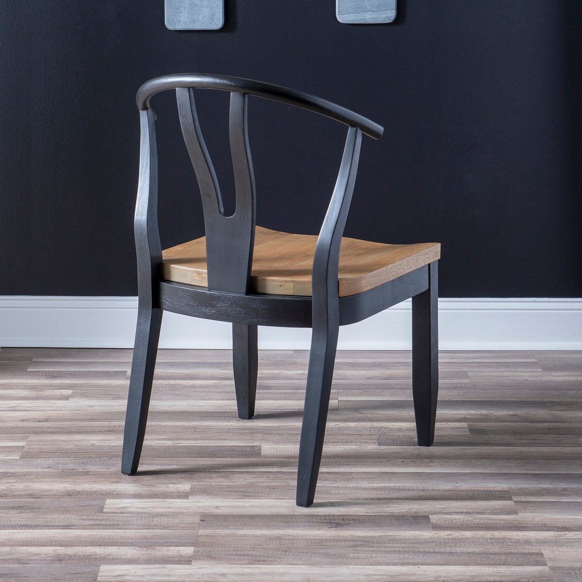 Franklin Wishbone Side Chair in Dining height. Harvest Oak seats on quartered white oak veneer sit atop aged black painted bases with interesting curves throughout the design. Available in Counter Height.
