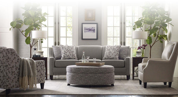 Classic sofa paired with accent armchairs and cocktail ottoman in a conversation layout