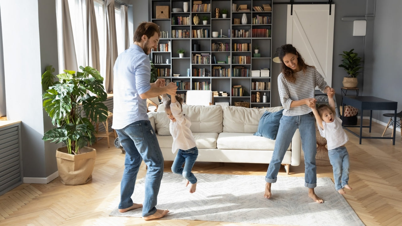 Family playing together in a living room at Furniture Fair