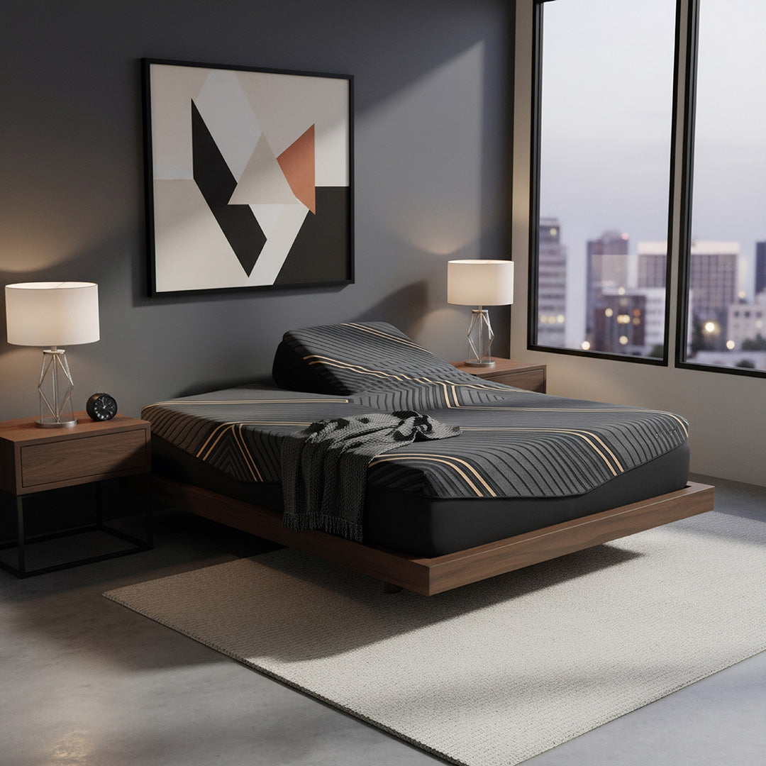 Alpine flex head split queen memory foam mattress on a low platform bed in a modern loft bedroom with city skyline windows