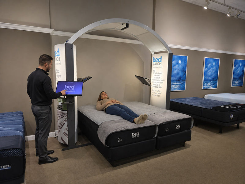 Customer testing mattress on bedMATCH diagnostic pressure mapping system at Furniture Fair