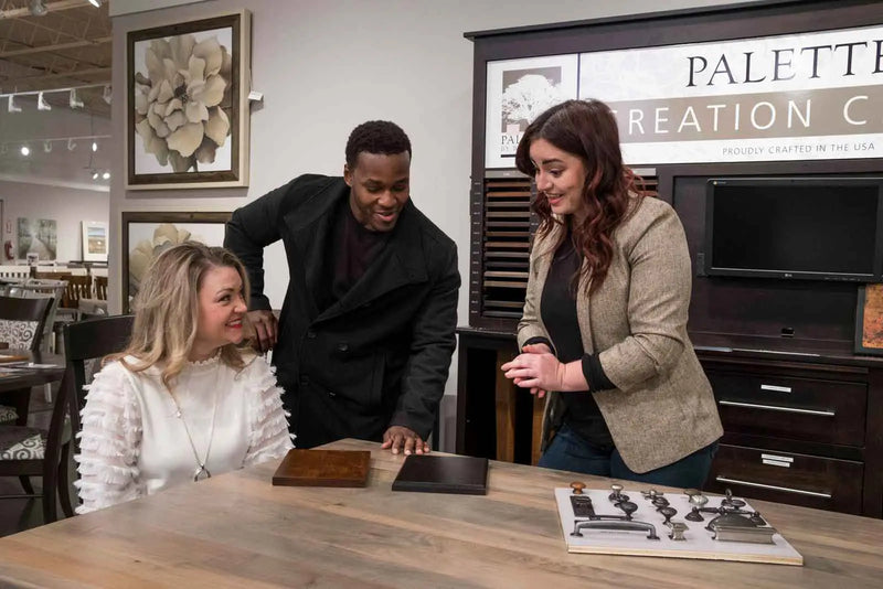 Customers comparing custom wood finish swatches at Furniture Fair Design Center