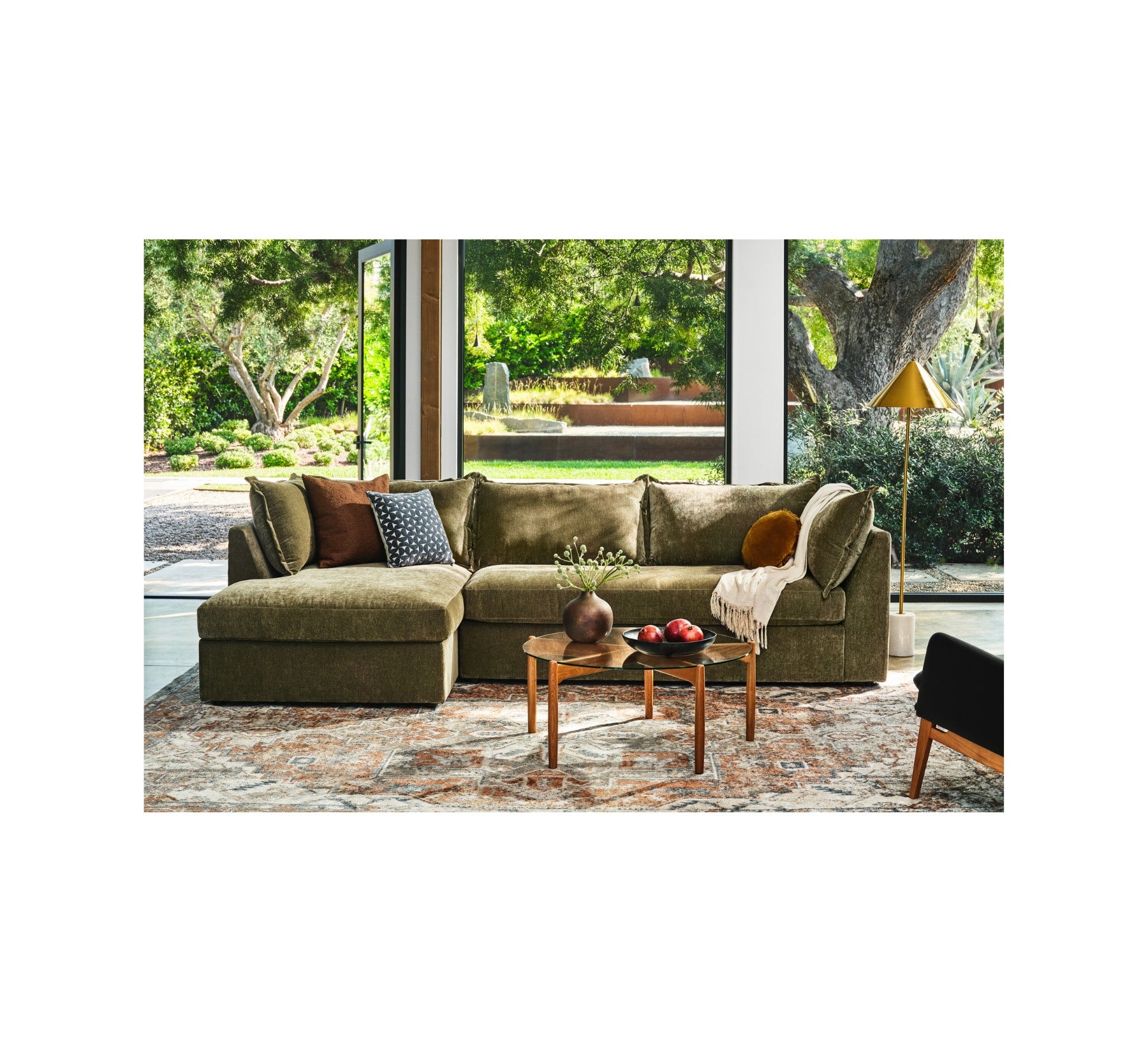Olive Joybird sectional in an indoor-outdoor living space