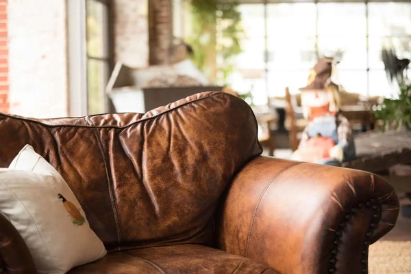 Close-up of fine-grained dark brown leather upholstery texture showing natural pebbled grain