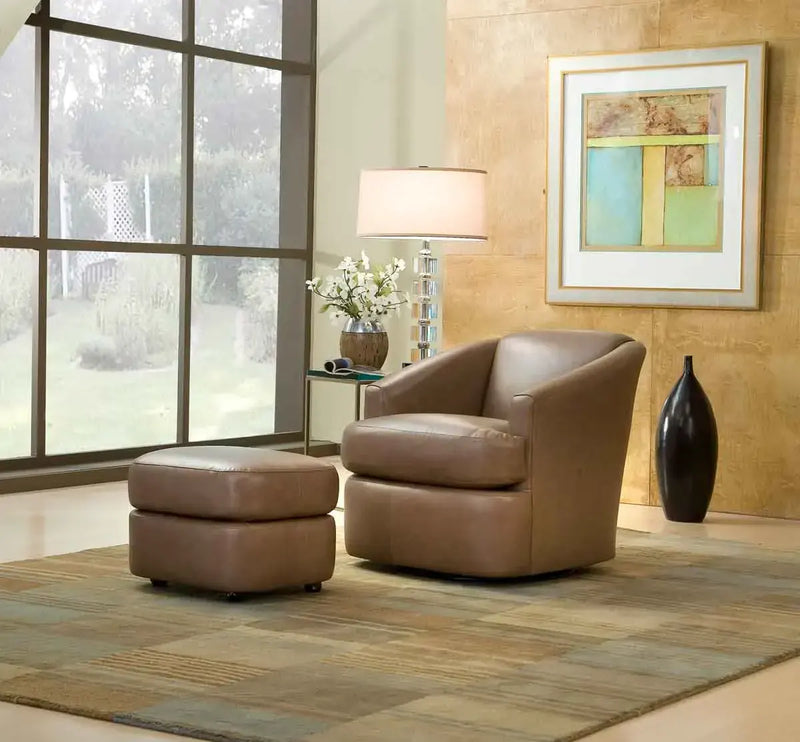 Tufted brown leather armchair with white accent pillow and throw blanket in a cozy home setting