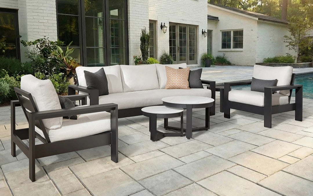 Outdoor lounge set with sofa, two armchairs, and nested coffee tables on a stone patio, the Best Seats in the House prize at The Great Picnic