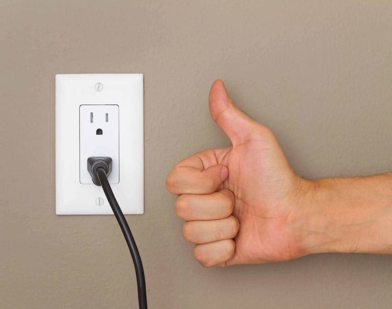 Zach Sullivan verifying power recliner connection to wall outlet