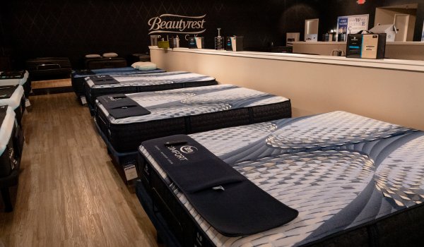 Beautyrest Black mattress display row with silver wall sign