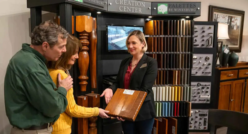 Customers reviewing dining table options with an interior designer at Furniture Fair Design Center