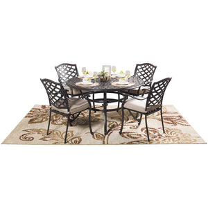 The Halston Round Dining Set - A complete outdoor dining set featuring a round dining table and four dining chairs. Made with high-quality, weather-resistant materials for durability. The dining chairs are designed with plush cushions for optimal comfort. The cast aluminum table is sturdy and spacious enough to seat all guests. All pieces of this set are in an Espresso Brown finish and feature a lattice design to unify the collection.