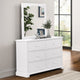 White dresser with mirror in a room with a window and plant