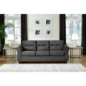The Miravel Sofa by Ashley Furniture in Gunmetal - A sleek and stylish sofa with contemporary design. Upholstered in a strong gunmetal fabric, this sofa features clean lines and a comfortable seating arrangement. The gunmetal color adds a touch of sophistication to any living space. With its plush cushions and sturdy frame, the Miravel Sofa offers both comfort and durability. Perfect for lounging or entertaining guests, this sofa is a perfect addition to modern home decor.