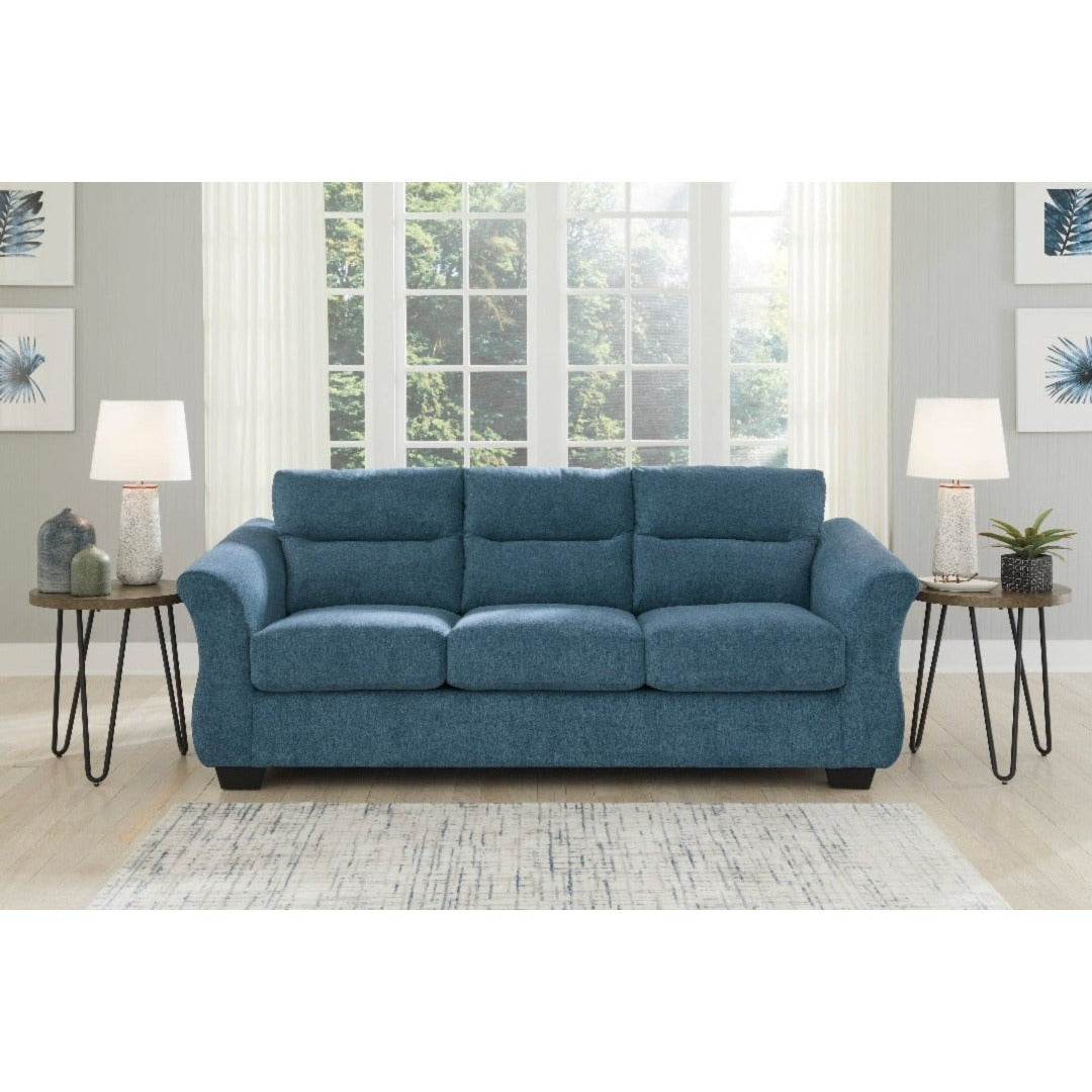The Miravel Sleeper Sofa by Ashley Furniture in Indigo - A sleek and stylish sofa with contemporary design. Upholstered in a rich indigo fabric, this sofa features clean lines and a comfortable seating arrangement. The deep indigo color adds a touch of sophistication to any living space. With its plush cushions and sturdy frame, the Miravel Sleeper Sofa offers both comfort and durability. Perfect for lounging or entertaining guests, this sofa is a perfect addition to modern home decor.